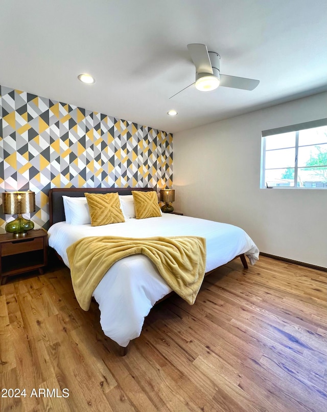 bedroom with light hardwood / wood-style flooring and ceiling fan