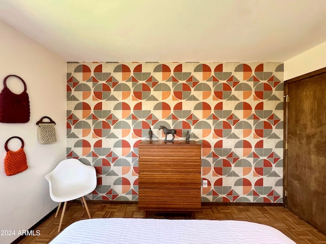 bedroom featuring tile walls and dark parquet floors