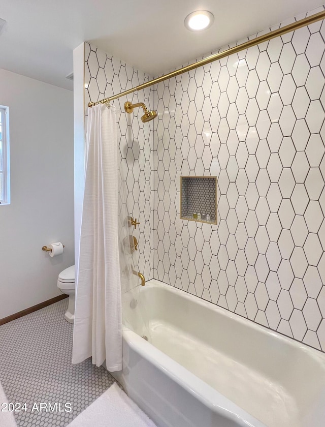 bathroom with shower / bath combination with curtain, tile patterned floors, and toilet