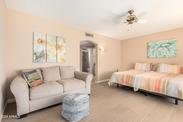 bedroom with a textured ceiling and ceiling fan