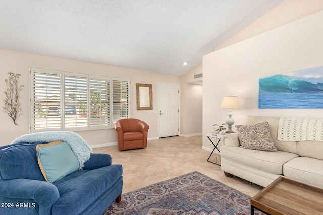 tiled living room with vaulted ceiling and a textured ceiling