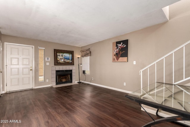 16225 N 30th St Unit 11, Phoenix, AZ 85032 - unfurnished living room with baseboards, a tiled fireplace, and wood finished floors