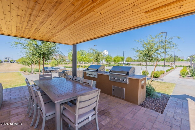 view of patio featuring an outdoor kitchen and a grill