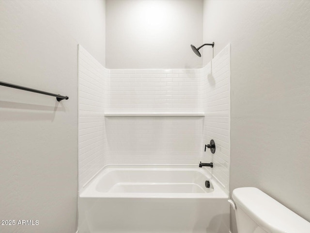 bathroom featuring bathtub / shower combination and toilet