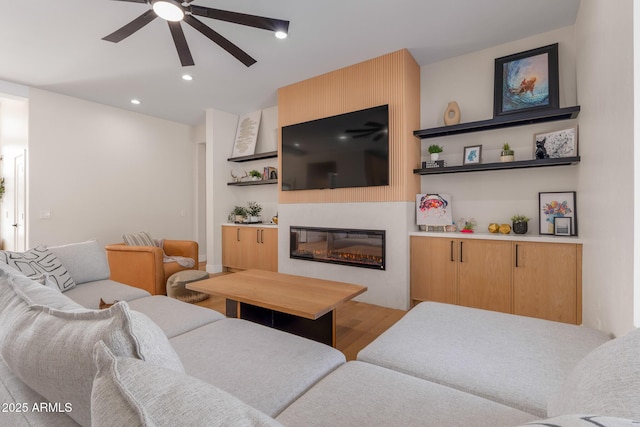 living room featuring ceiling fan and light wood-type flooring