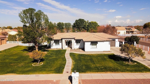 mediterranean / spanish-style home with a garage and a front yard