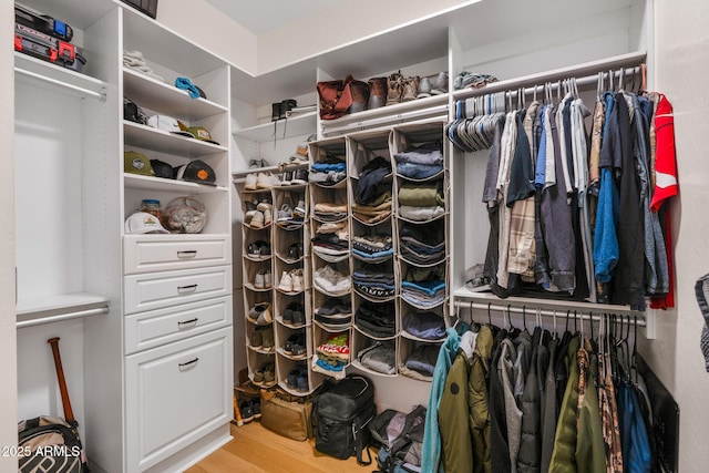 walk in closet featuring light hardwood / wood-style flooring