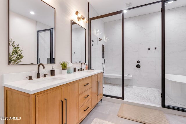 bathroom with tile patterned floors, vanity, and an enclosed shower