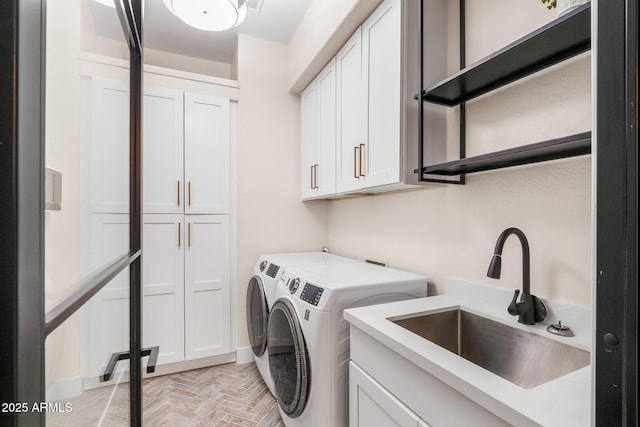 laundry room with separate washer and dryer, sink, cabinets, and light parquet floors