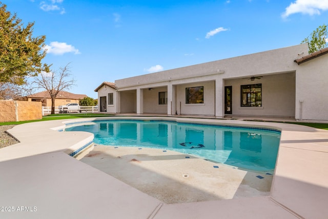 view of pool with a patio and ceiling fan