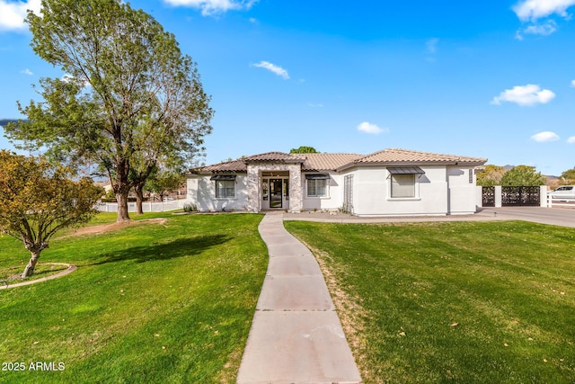 mediterranean / spanish home featuring a front yard