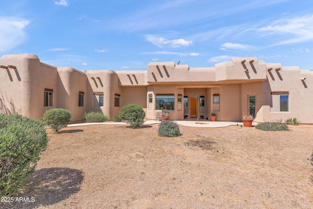 back of house with stucco siding