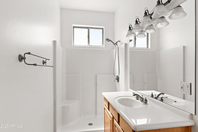 full bath with plenty of natural light, vanity, and a shower