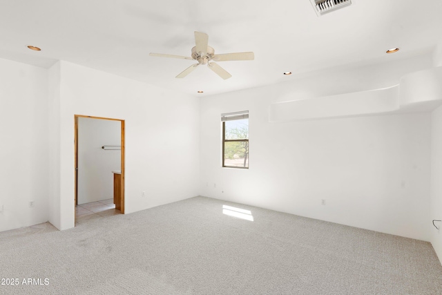 carpeted empty room featuring visible vents, recessed lighting, and ceiling fan