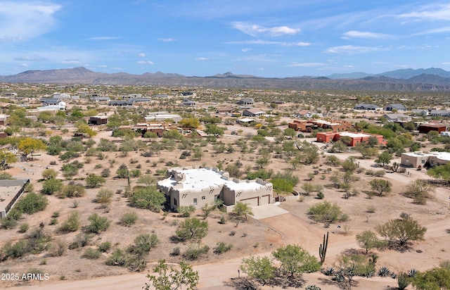 drone / aerial view featuring view of desert and a mountain view