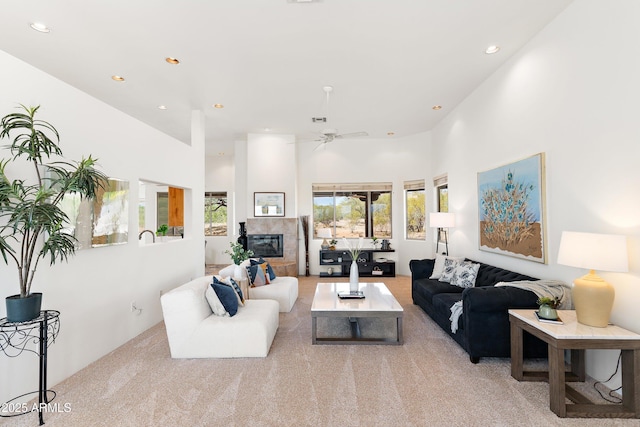 living area with ceiling fan, a wealth of natural light, recessed lighting, and light colored carpet