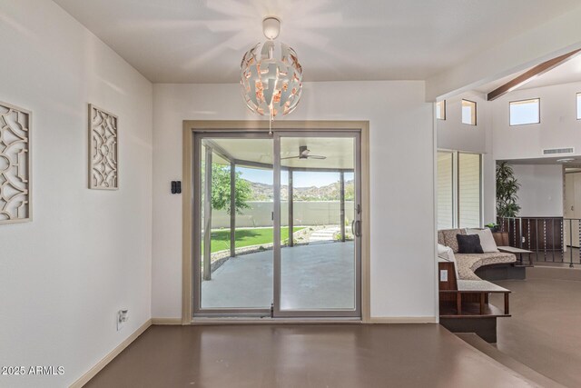1545 E Christy Dr, Phoenix, AZ 85020 - doorway featuring healthy amount of natural light, baseboards, concrete floors, and beam ceiling