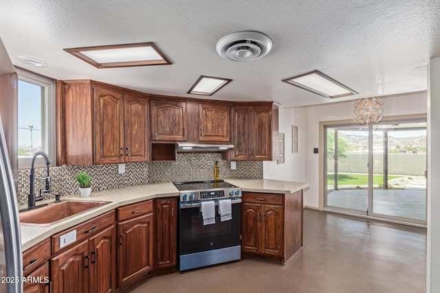 1545 E Christy Dr, Phoenix, AZ 85020 - kitchen featuring stainless steel electric range oven, a sink, finished concrete flooring, decorative backsplash, and light countertops