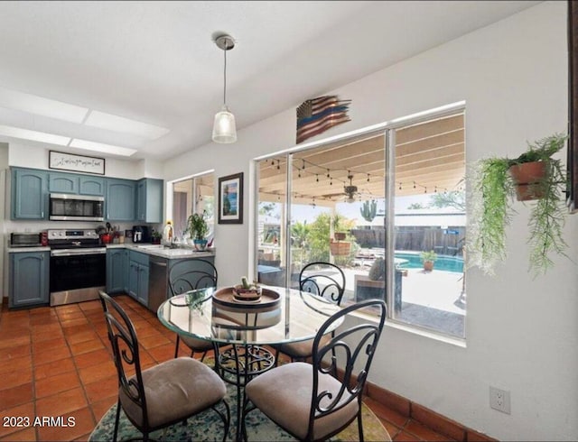 dining space featuring sink and dark tile patterned flooring