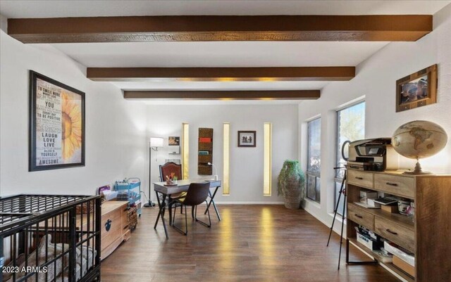 dining area featuring beamed ceiling and dark wood-type flooring