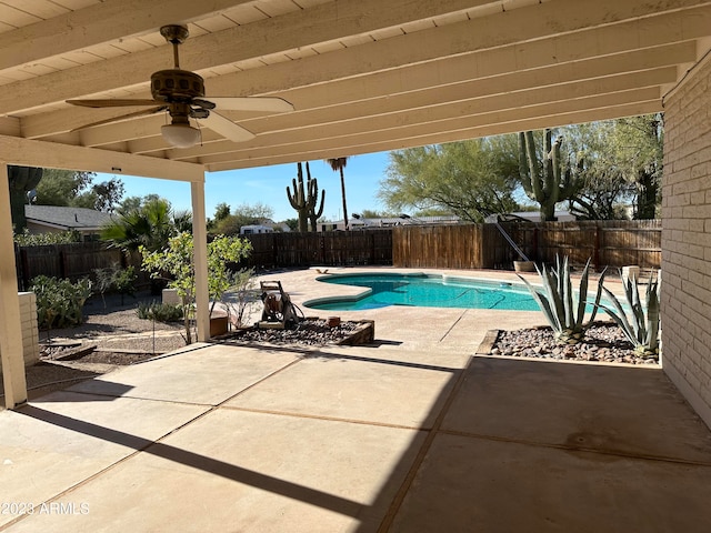 view of swimming pool featuring ceiling fan and a patio