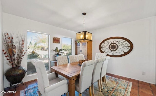 tiled dining space with an inviting chandelier