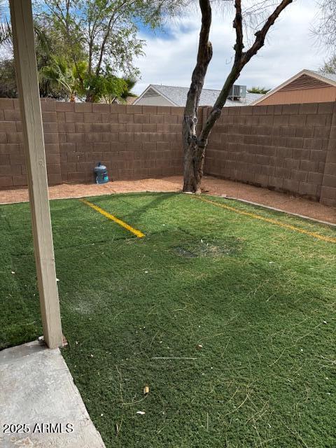 view of yard with a fenced backyard