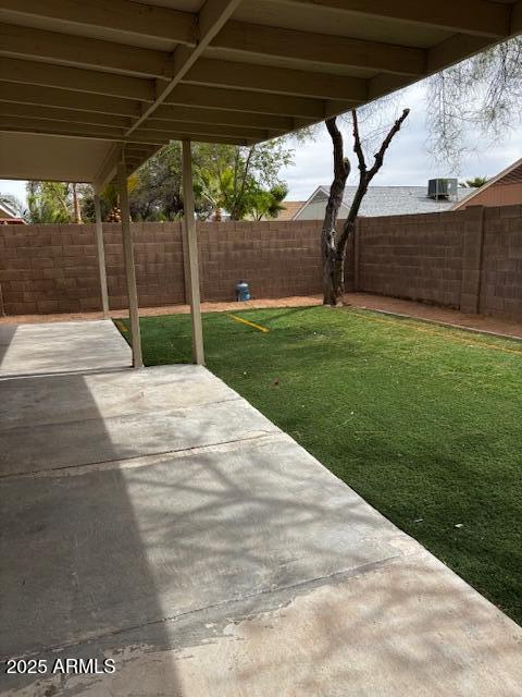 view of yard featuring a patio area and a fenced backyard