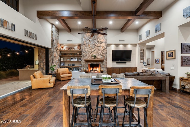 4610 E Meadowview Dr, Gilbert, AZ 85298 - living area featuring a ceiling fan, wood-type flooring, a stone fireplace, beam ceiling, and recessed lighting