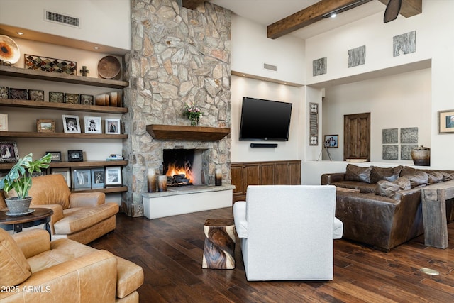 4610 E Meadowview Dr, Gilbert, AZ 85298 - living area featuring beam ceiling, a towering ceiling, hardwood / wood-style flooring, and a stone fireplace