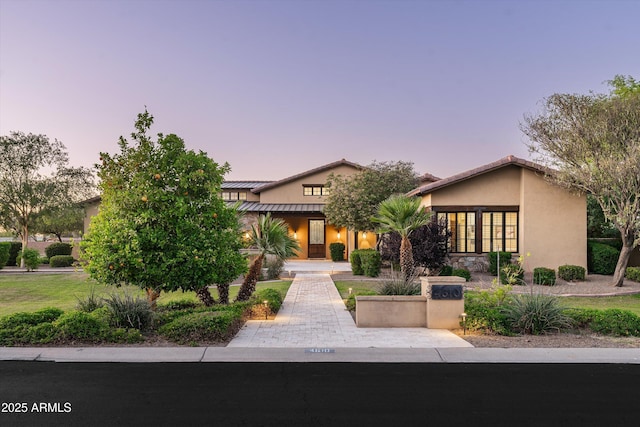 4610 E Meadowview Dr, Gilbert, AZ 85298 - view of front of house featuring a standing seam roof, stucco siding, and metal roof
