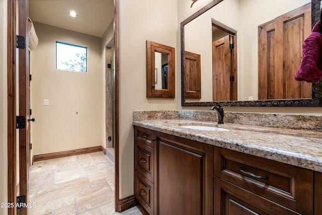 4610 E Meadowview Dr, Gilbert, AZ 85298 - full bath with vanity, stone tile flooring, baseboards, and recessed lighting