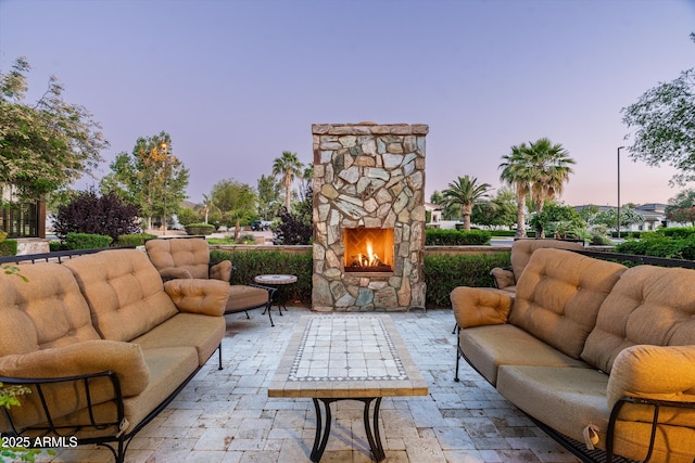 4610 E Meadowview Dr, Gilbert, AZ 85298 - patio terrace at dusk featuring an outdoor living space with a fireplace and a patio area