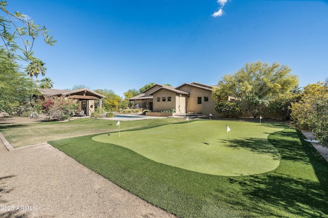 4610 E Meadowview Dr, Gilbert, AZ 85298 - view of yard featuring a putting green, an outdoor pool, and a patio area