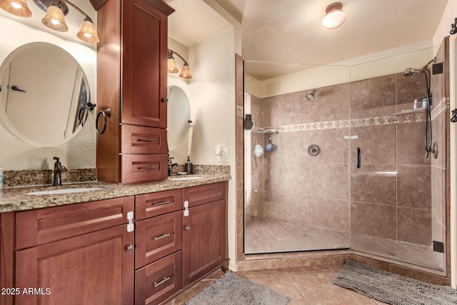 bathroom featuring tile patterned flooring, vanity, and walk in shower