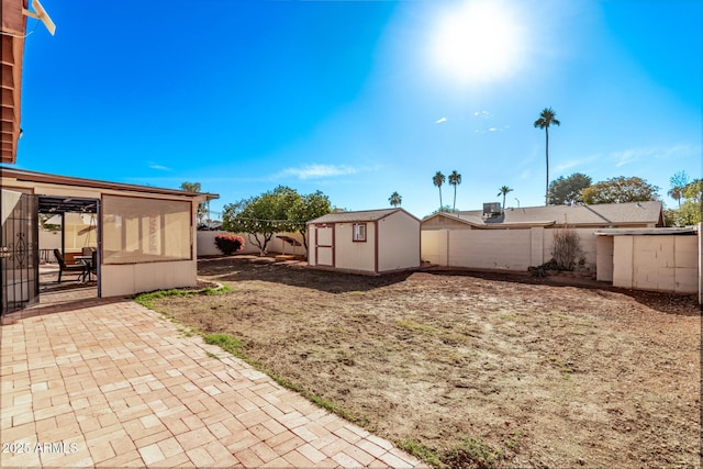 view of yard featuring a patio and a storage shed