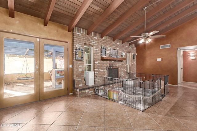 tiled living room featuring ceiling fan, french doors, wooden ceiling, beamed ceiling, and high vaulted ceiling