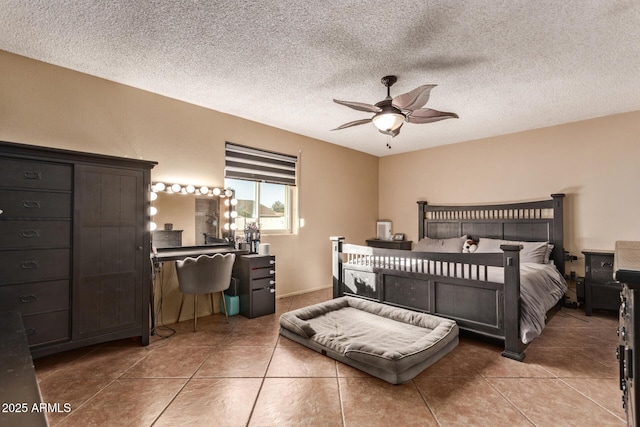 bedroom with a textured ceiling, tile patterned floors, and ceiling fan