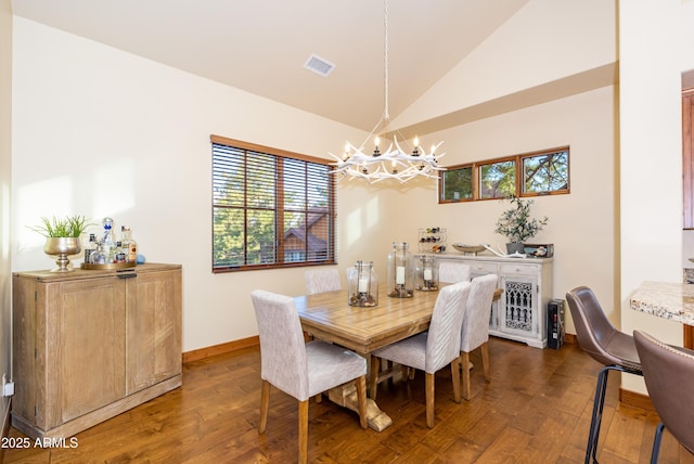 dining room featuring lofted ceiling, dark hardwood / wood-style floors, and a notable chandelier