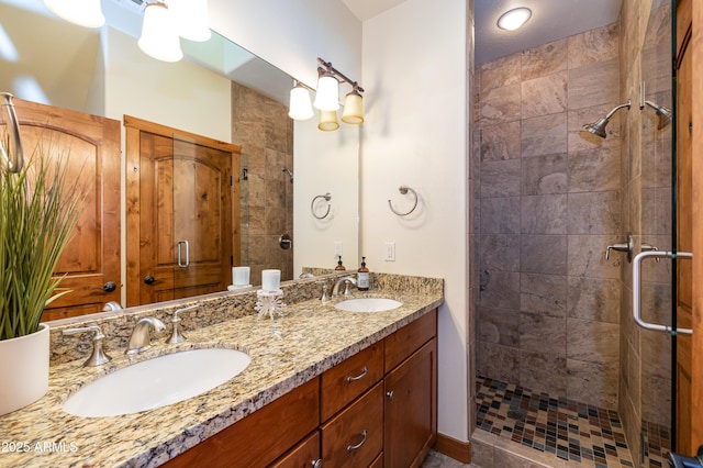 bathroom featuring vanity and a shower with door