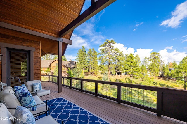 wooden terrace with an outdoor hangout area