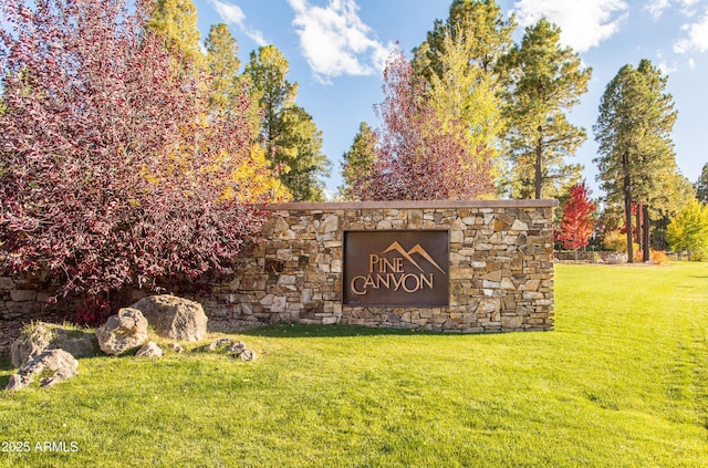 community / neighborhood sign with a lawn