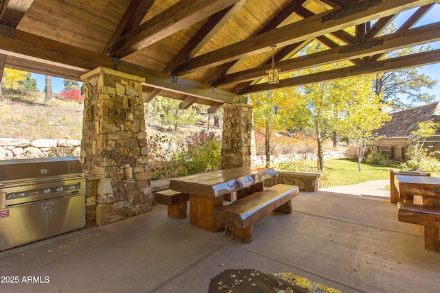 view of patio with area for grilling and a gazebo