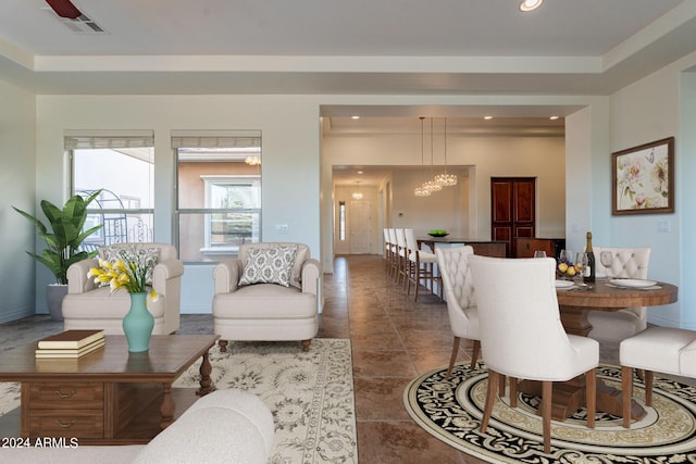 living room with tile patterned floors and a chandelier