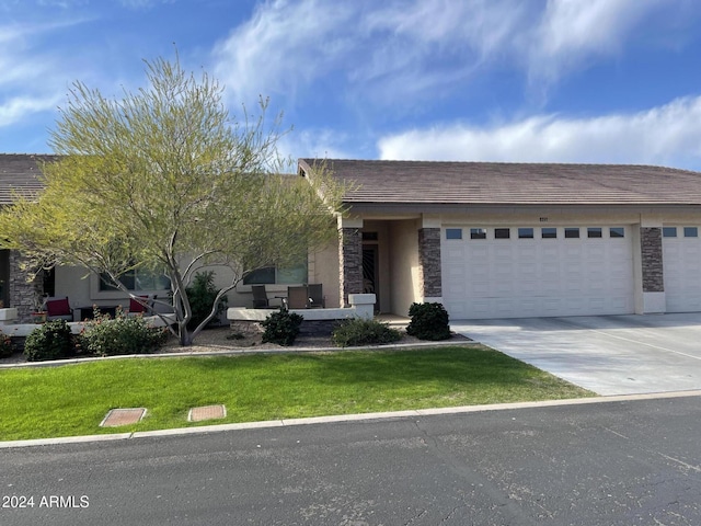 view of front of property with a garage and a front lawn