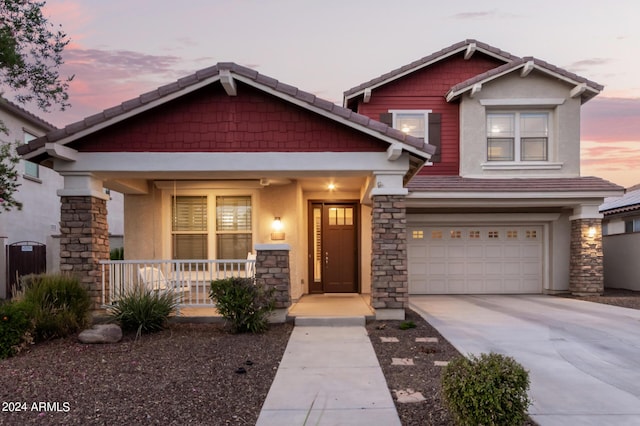 craftsman inspired home with covered porch and a garage