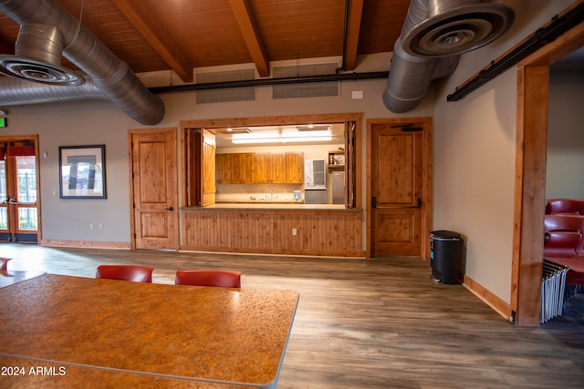 unfurnished living room featuring beamed ceiling, wood ceiling, and wood-type flooring