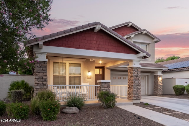 craftsman-style house with a garage and covered porch