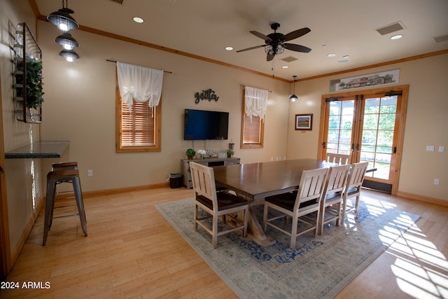 dining area featuring ceiling fan, light hardwood / wood-style floors, ornamental molding, and french doors