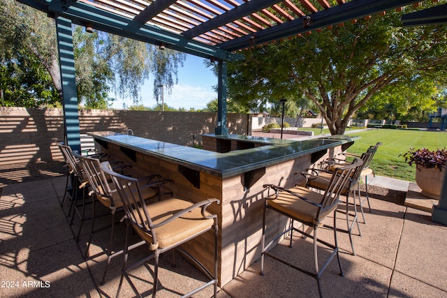 view of patio / terrace with a pergola and exterior bar